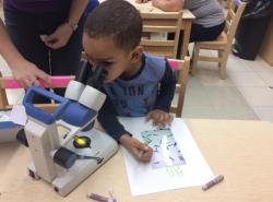 一个孩子在显微镜下观察